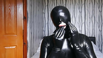 Soumise Gainée De Latex Retenue Et Réduite Au Silence Avec Un Bâillon